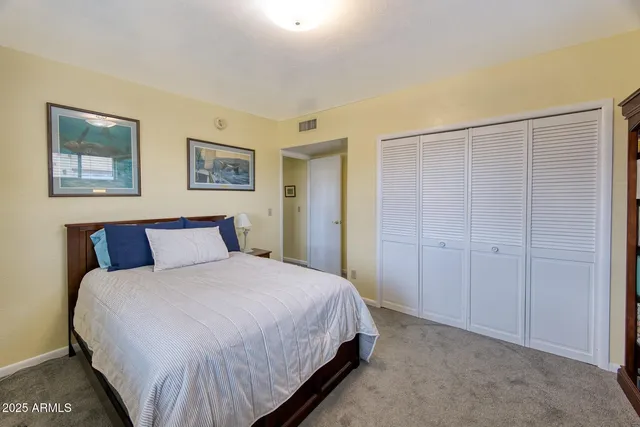 a bedroom with a bed and a bookshelf