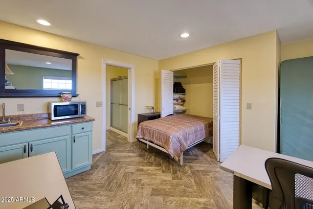 a bathroom with a granite countertop shower and a sink