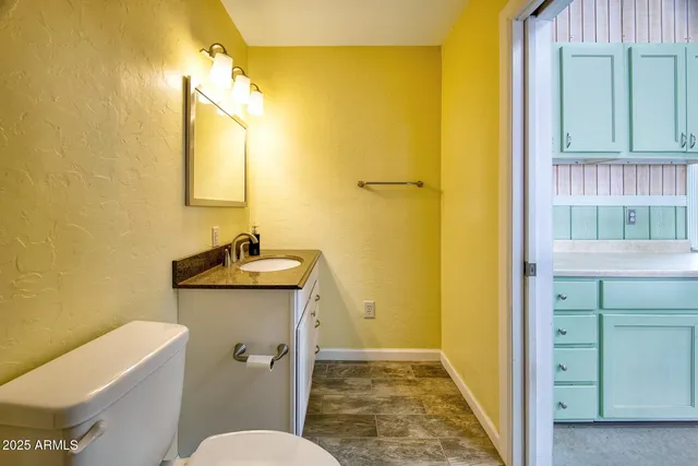 a kitchen with a table chairs and a refrigerator