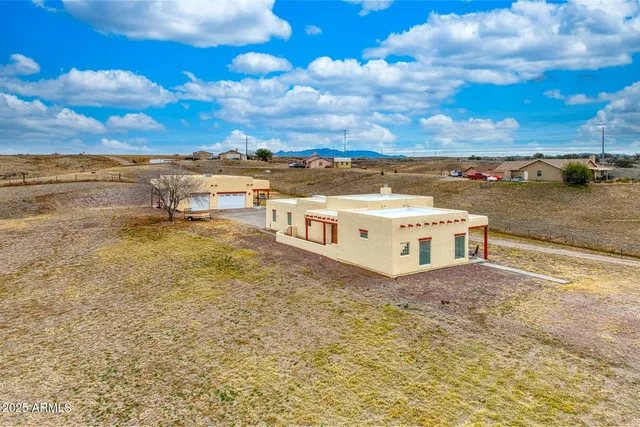 a view of a terrace with lawn chairs
