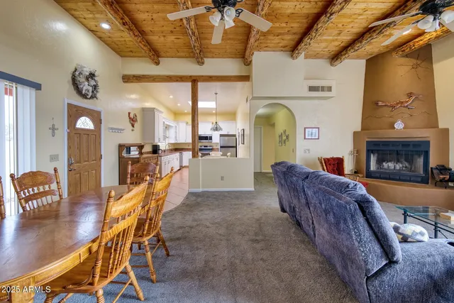 a living room with furniture a fireplace and a table