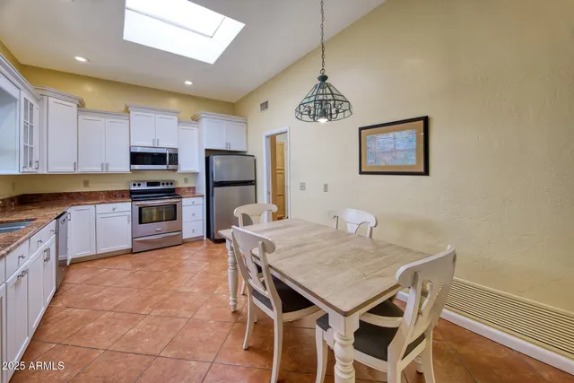a kitchen with a dining table and chairs