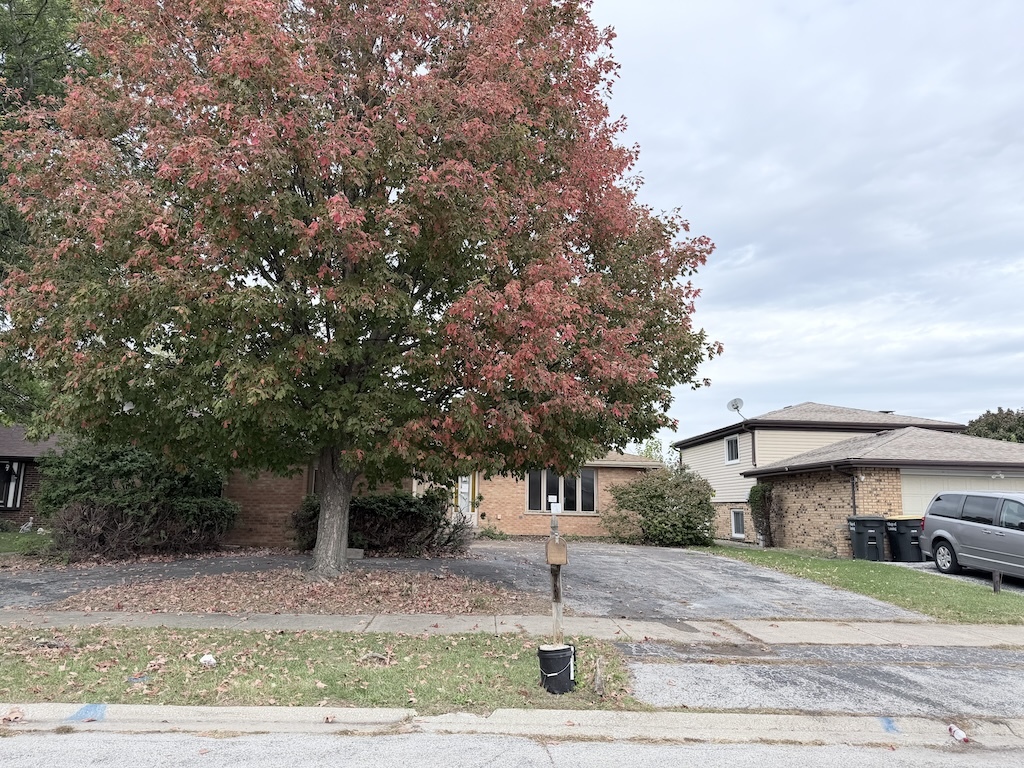3312 192nd Place Lansing, IL 60438 - Photo 15 of 18 a front view of a house with a yard and garage