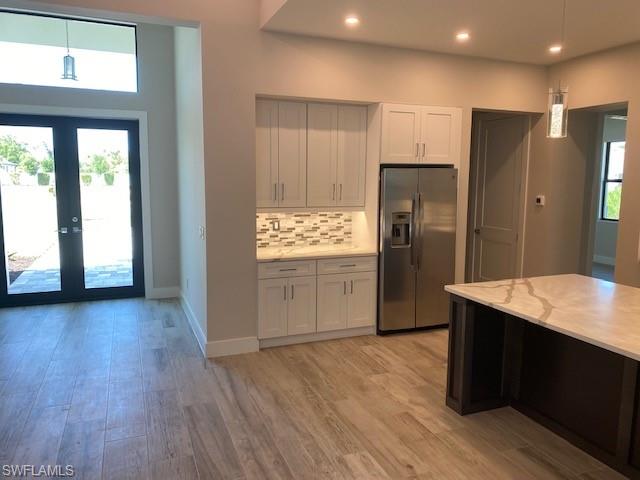 10 Willoughby Drive Naples, FL 34110 - Photo 3 of 11 a kitchen with stainless steel appliances granite countertop a refrigerator and a sink