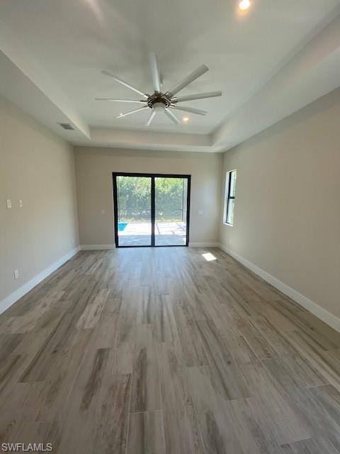 10 Willoughby Drive Naples, FL 34110 - Photo 6 of 11 wooden floor in an empty room with a window
