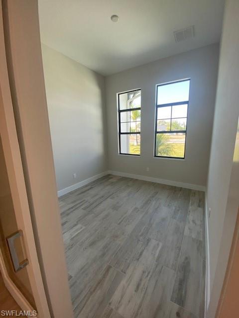 10 Willoughby Drive Naples, FL 34110 - Photo 9 of 11 a view of room with window and hardwood floor
