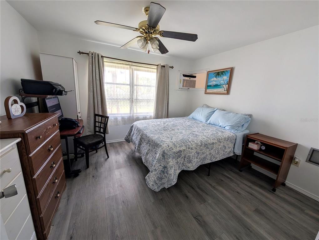 5929 Easy Street, Unit I23 Bradenton, FL 34207 - Photo 11 of 24 a bedroom with a bed and a chandelier