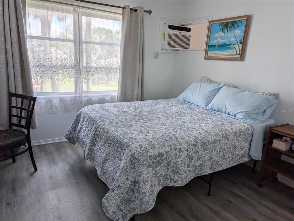 5929 Easy Street, Unit I23 Bradenton, FL 34207 - Photo 12 of 24 a bedroom with a bed a dresser and next to a window