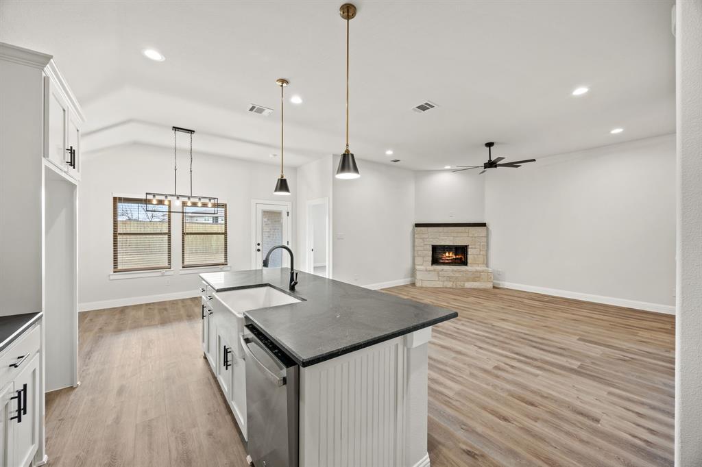 104 Maverick Trail Valley View, TX 76272 - Photo 29 of 30 a open kitchen with a sink a large window and wooden floor
