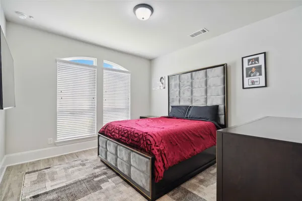 a bedroom with a large bed and a window