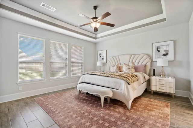 a spacious bedroom with a bed and a large window