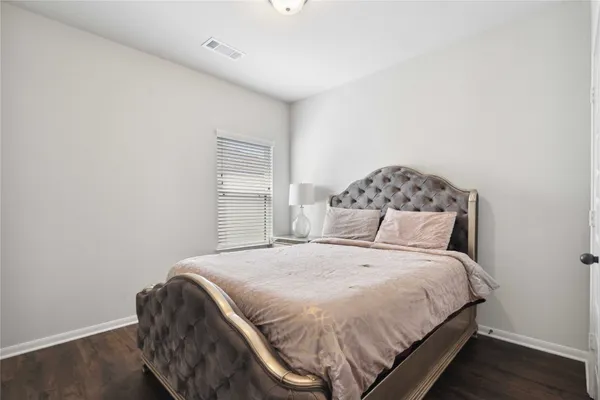 a bed sitting in a bedroom next to a window