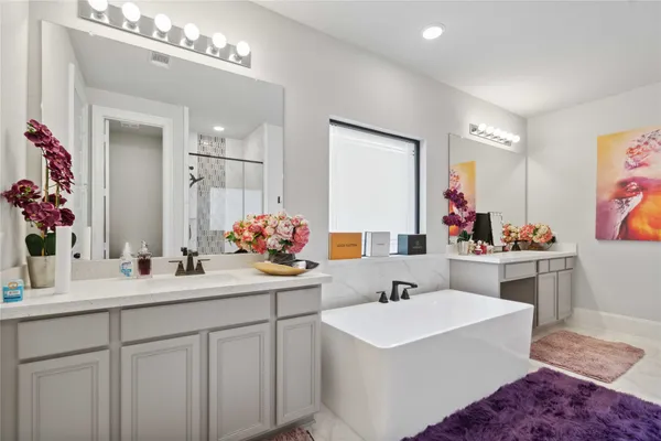 a bathroom with a sink vanity and mirror