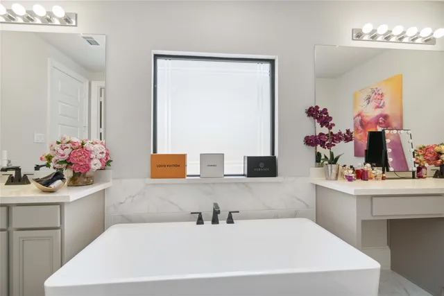 a bathroom with a sink a vanity and a mirror