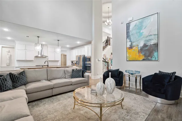 a living room with furniture and kitchen view