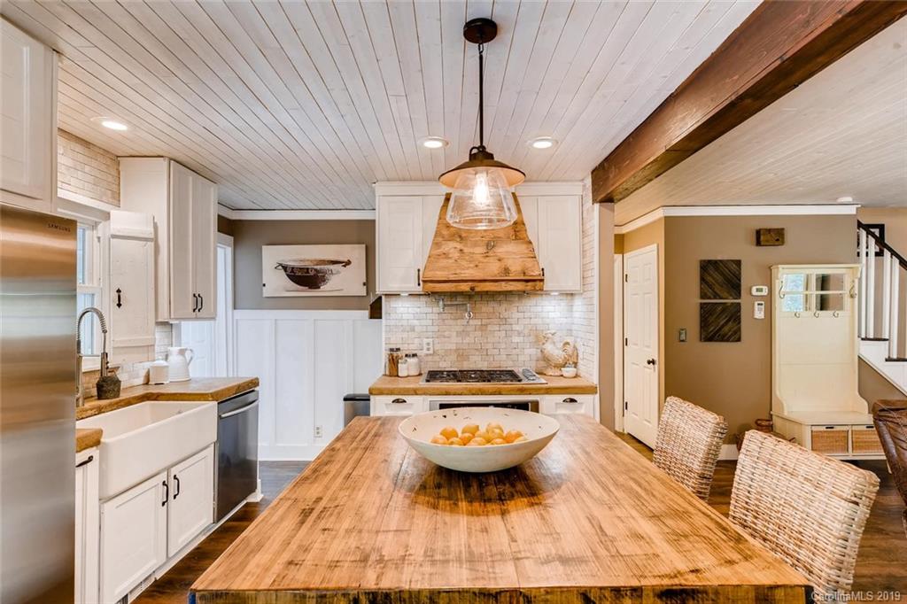 10840 Valley Hill Road Indian Land, SC 29707 - Photo 11 of 37 a kitchen with kitchen island granite countertop a sink stove and wooden cabinets