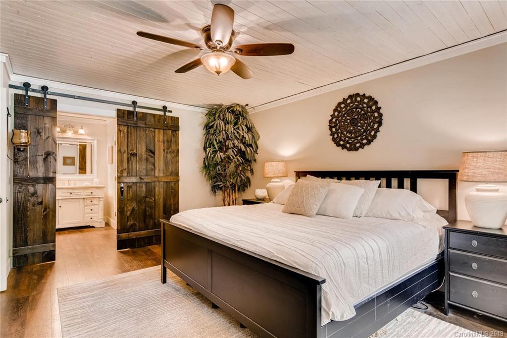 10840 Valley Hill Road Indian Land, SC 29707 - Photo 14 of 37 a large bed sitting in a bedroom next to a window