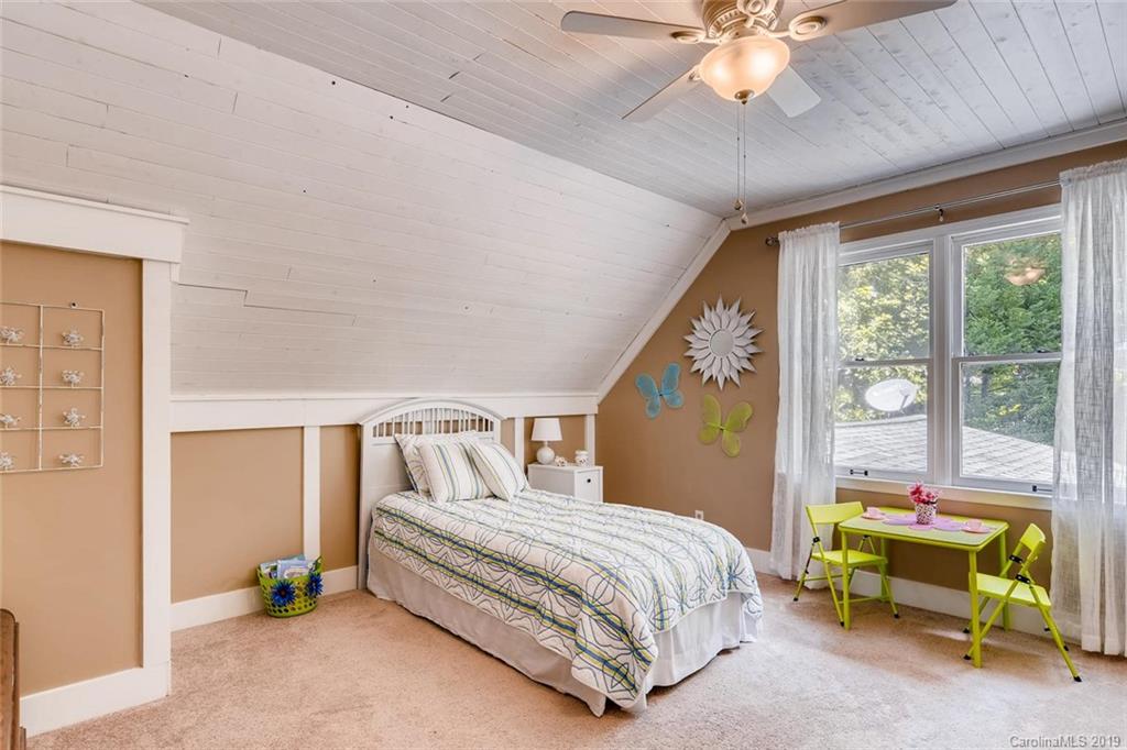 10840 Valley Hill Road Indian Land, SC 29707 - Photo 27 of 37 a bedroom with a bed and a chandelier