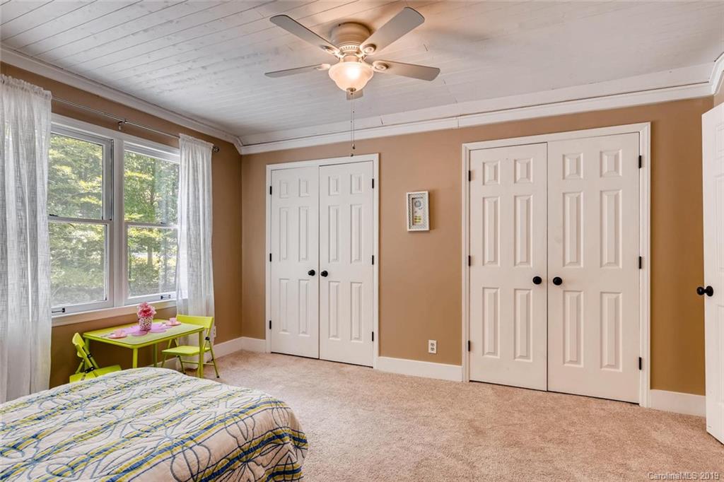 10840 Valley Hill Road Indian Land, SC 29707 - Photo 28 of 37 a bedroom with a bed a chandelier and a window