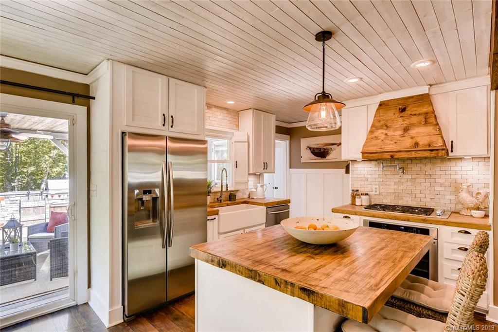 10840 Valley Hill Road Indian Land, SC 29707 - Photo 5 of 37 a kitchen with a table chairs stove and refrigerator
