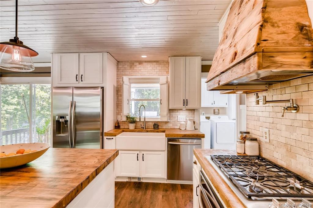 10840 Valley Hill Road Indian Land, SC 29707 - Photo 6 of 37 a kitchen with stainless steel appliances granite countertop a sink stove and refrigerator