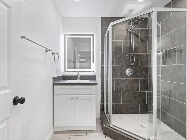 a bathroom with a shower and a sink