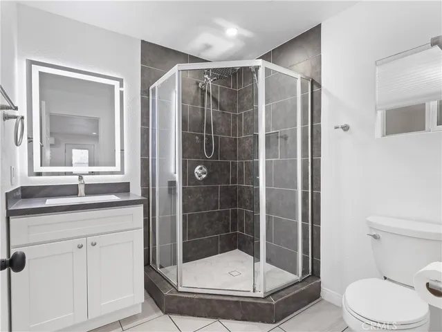 a bathroom with a shower a toilet and sink