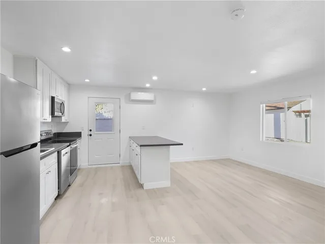 a view of a kitchen with a sink cabinets and wooden floor