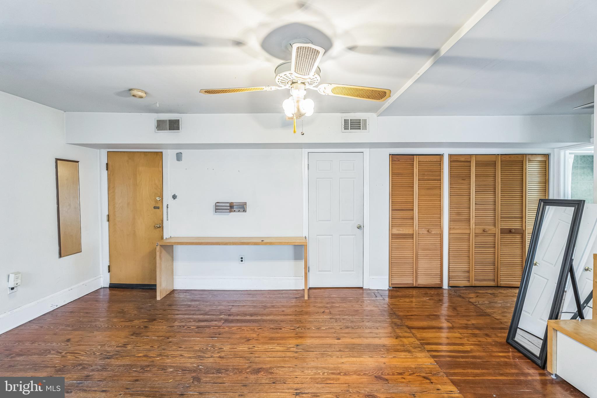 4417 Baker Street Philadelphia, PA 19127 - Photo 20 of 50 a view of a livingroom with wooden floor and a ceiling fan