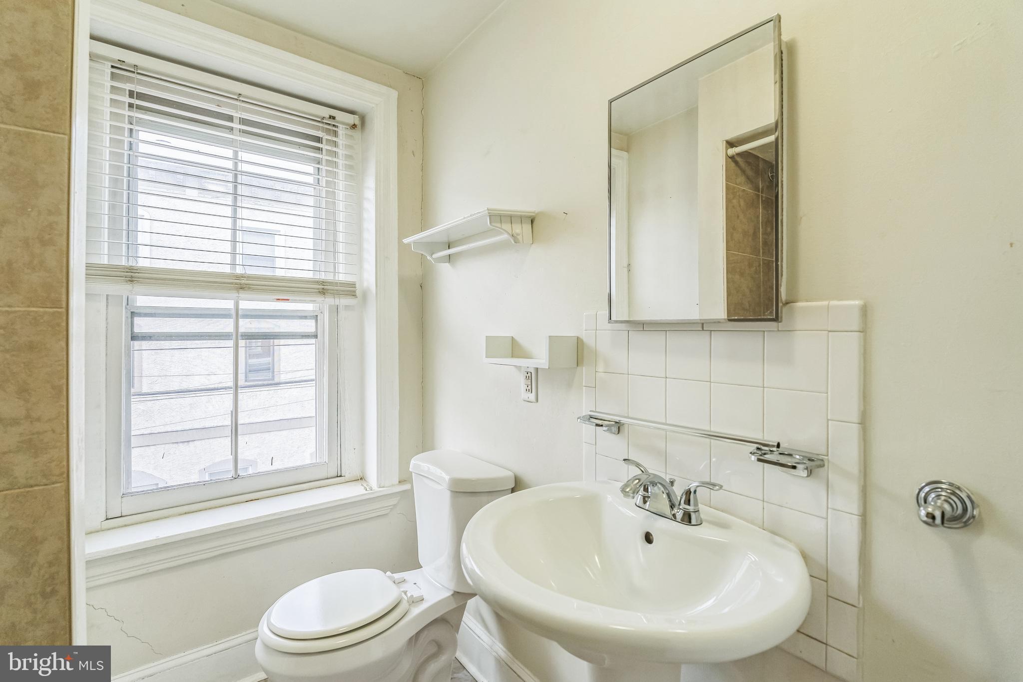 4417 Baker Street Philadelphia, PA 19127 - Photo 22 of 50 a bathroom with a sink a toilet and a bathtub