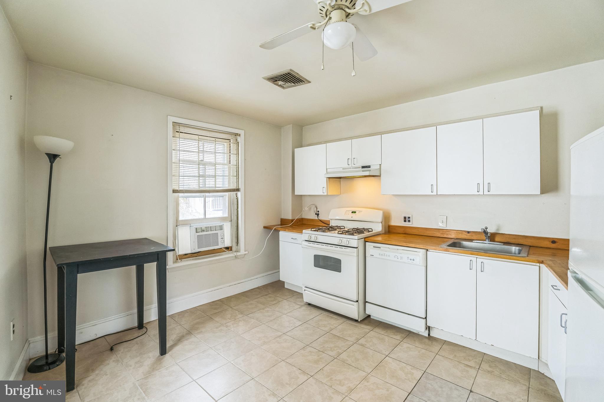 4417 Baker Street Philadelphia, PA 19127 - Photo 23 of 50 a kitchen with granite countertop white cabinets and white appliances
