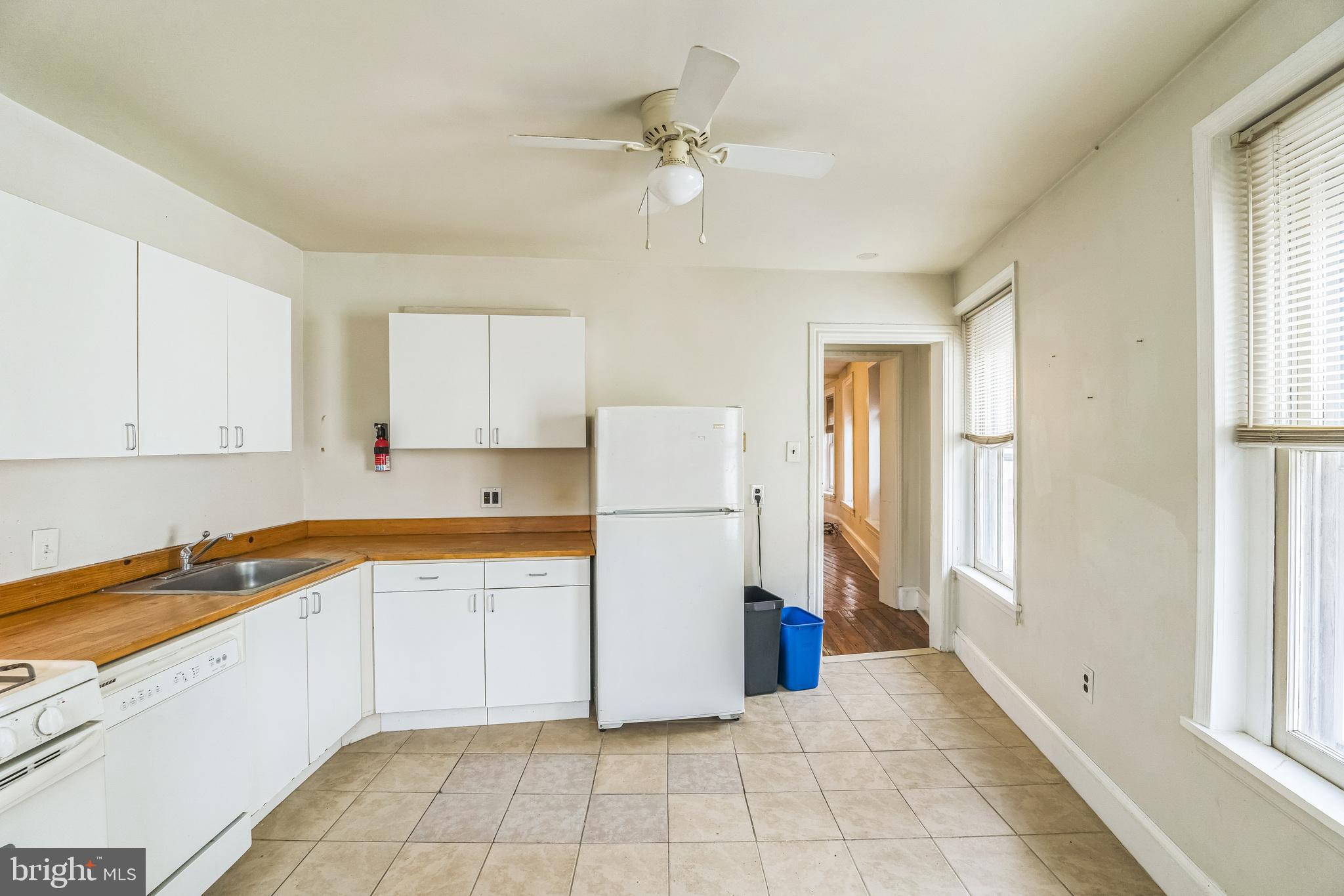 4417 Baker Street Philadelphia, PA 19127 - Photo 24 of 50 a kitchen with a refrigerator a stove top oven and cabinets