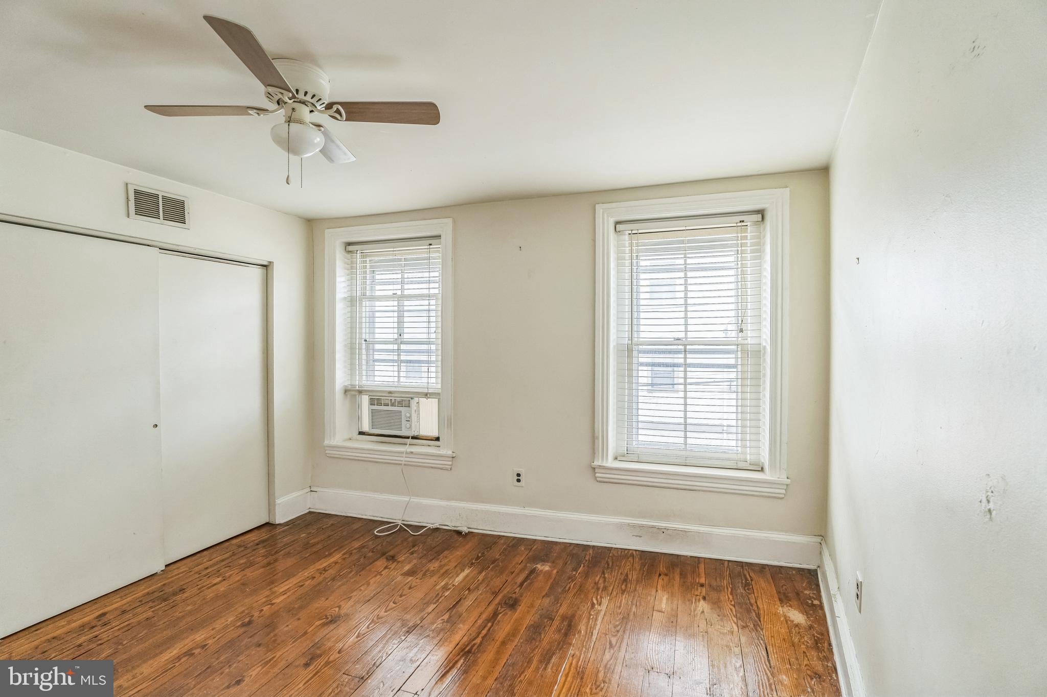 4417 Baker Street Philadelphia, PA 19127 - Photo 27 of 50 a view of an empty room with a window and wooden floor