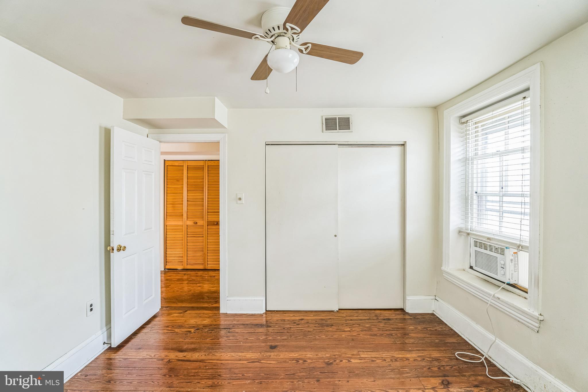 4417 Baker Street Philadelphia, PA 19127 - Photo 29 of 50 a view of an empty room with wooden floor and a window