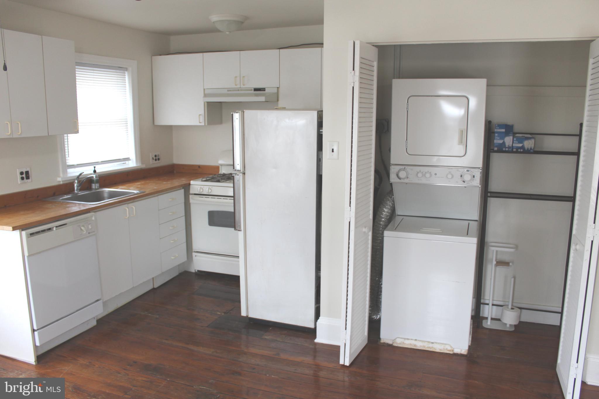 4417 Baker Street Philadelphia, PA 19127 - Photo 33 of 50 a kitchen with a refrigerator a sink and dishwasher with wooden floor
