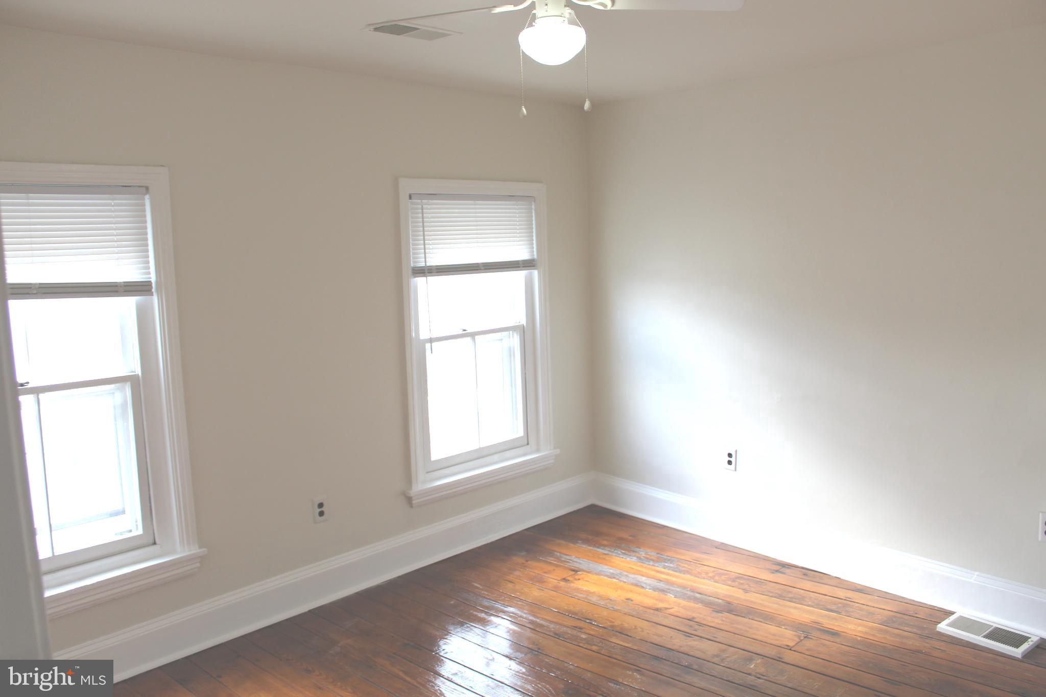 4417 Baker Street Philadelphia, PA 19127 - Photo 37 of 50 an empty room with wooden floor and windows