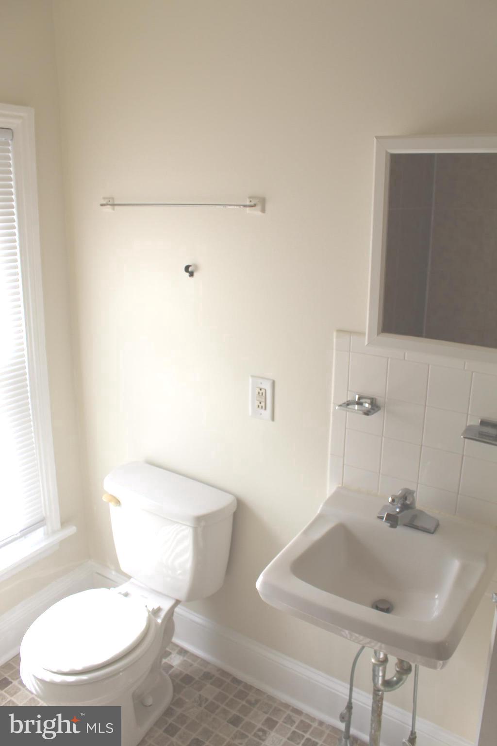 4417 Baker Street Philadelphia, PA 19127 - Photo 39 of 50 a bathroom with a sink and a mirror