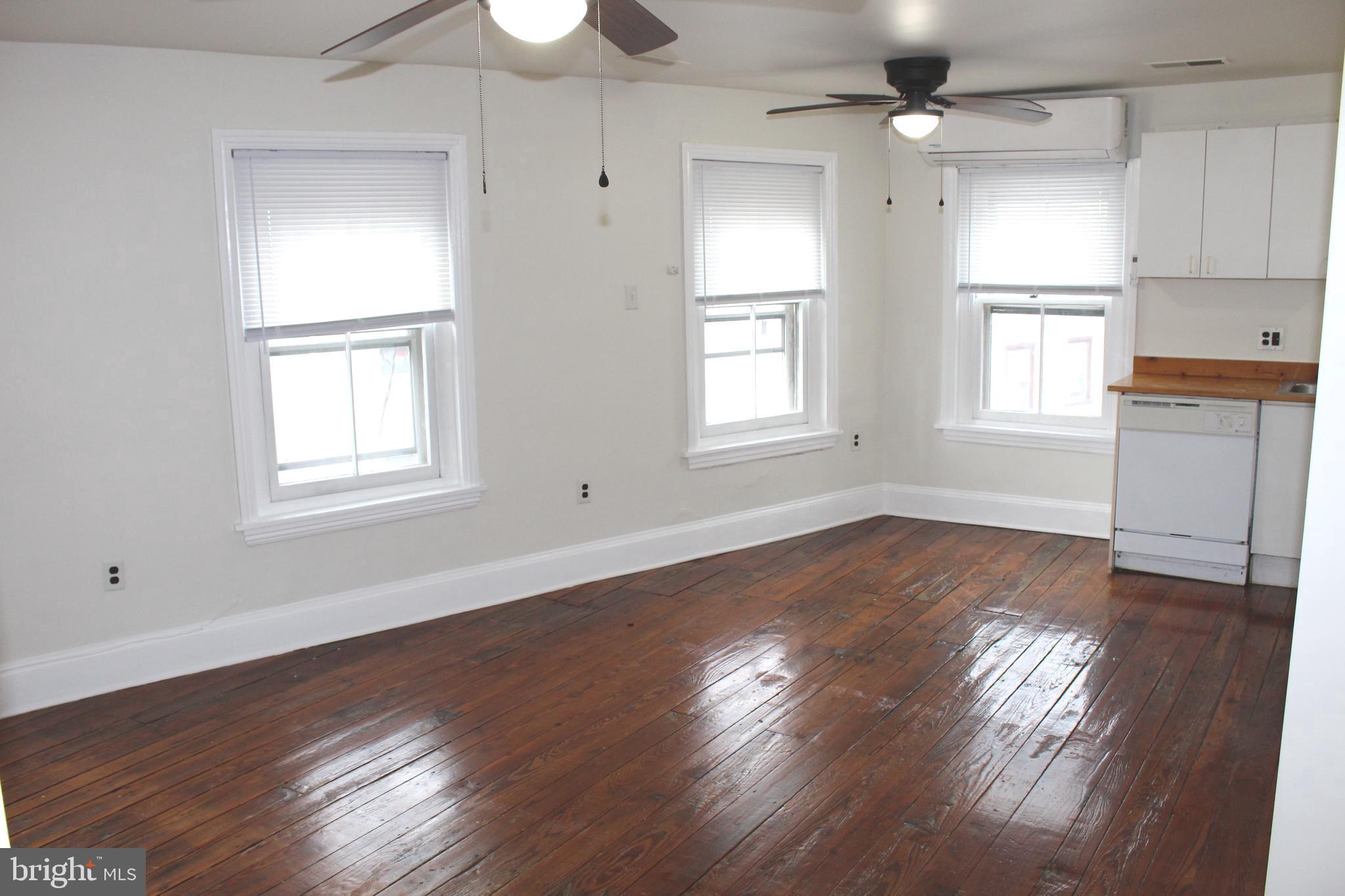 4417 Baker Street Philadelphia, PA 19127 - Photo 41 of 50 a view of an empty room with wooden floor and a window