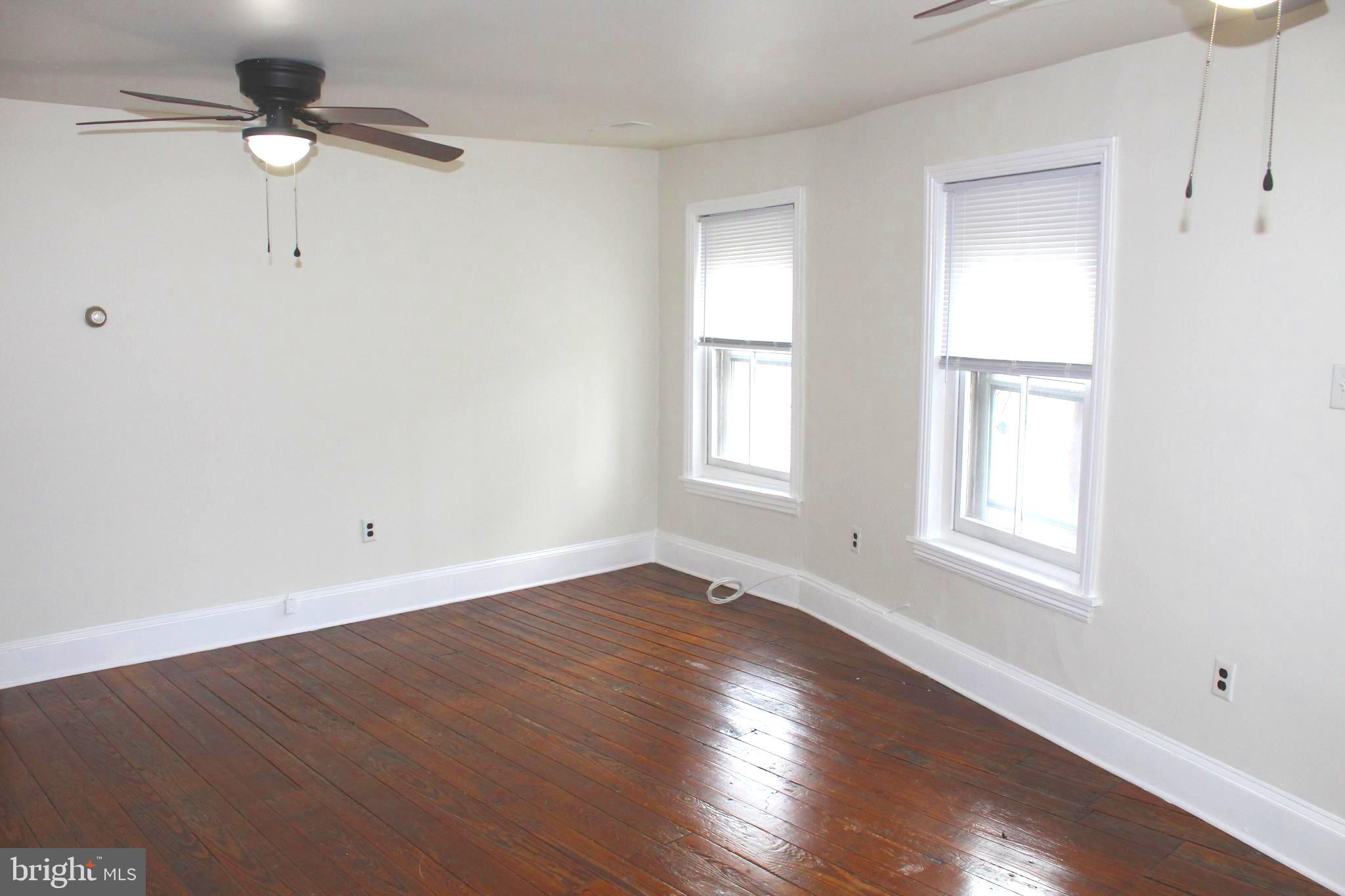 4417 Baker Street Philadelphia, PA 19127 - Photo 46 of 50 an empty room with wooden floor closet and windows
