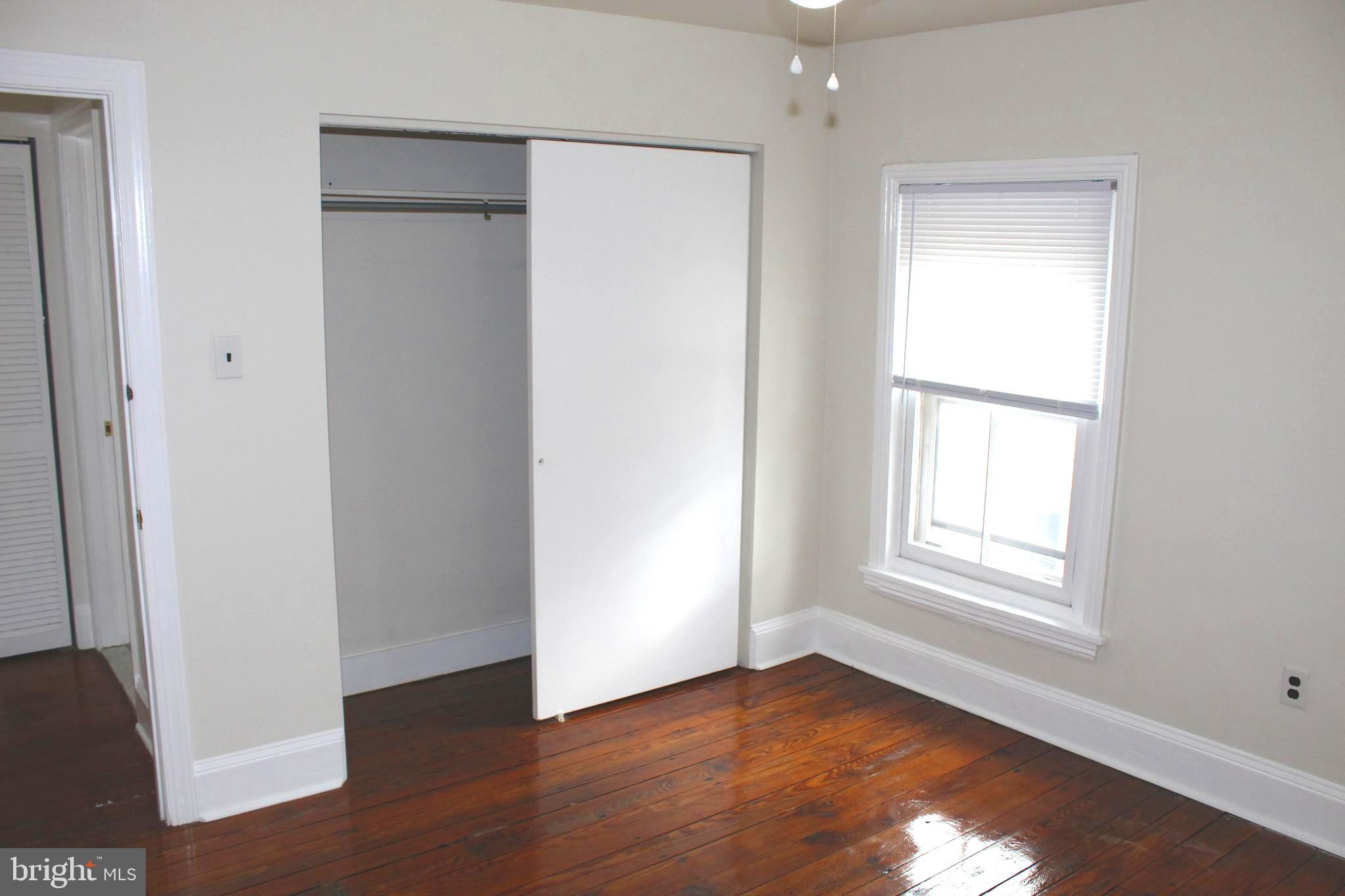 4417 Baker Street Philadelphia, PA 19127 - Photo 48 of 50 a view of an empty room with wooden floor and a window