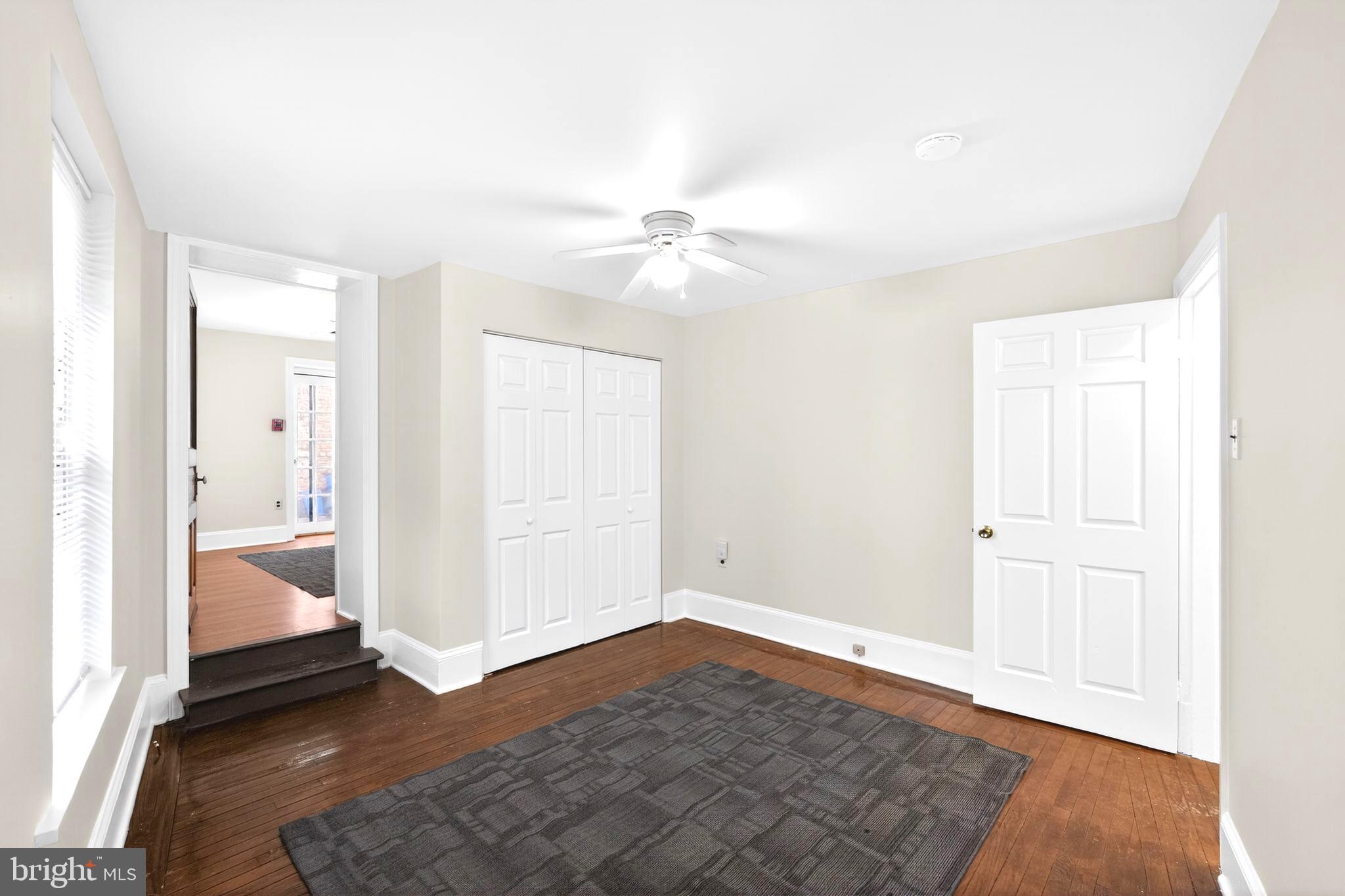 4417 Baker Street Philadelphia, PA 19127 - Photo 9 of 50 an empty room with wooden floor and a ceiling fan