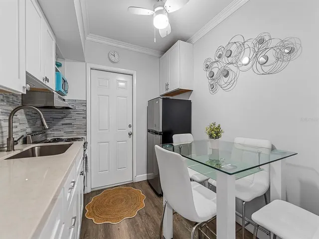 a kitchen with stainless steel appliances granite countertop a stove a sink dishwasher and cabinets with wooden floor