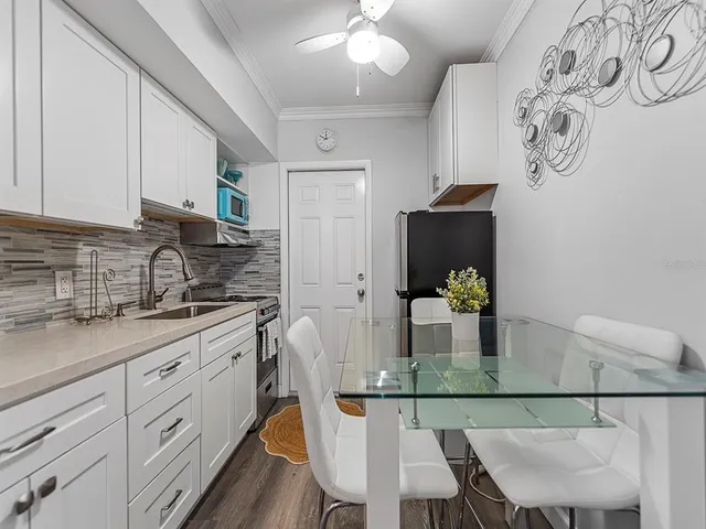 a spacious bedroom with a bed and a flat screen tv