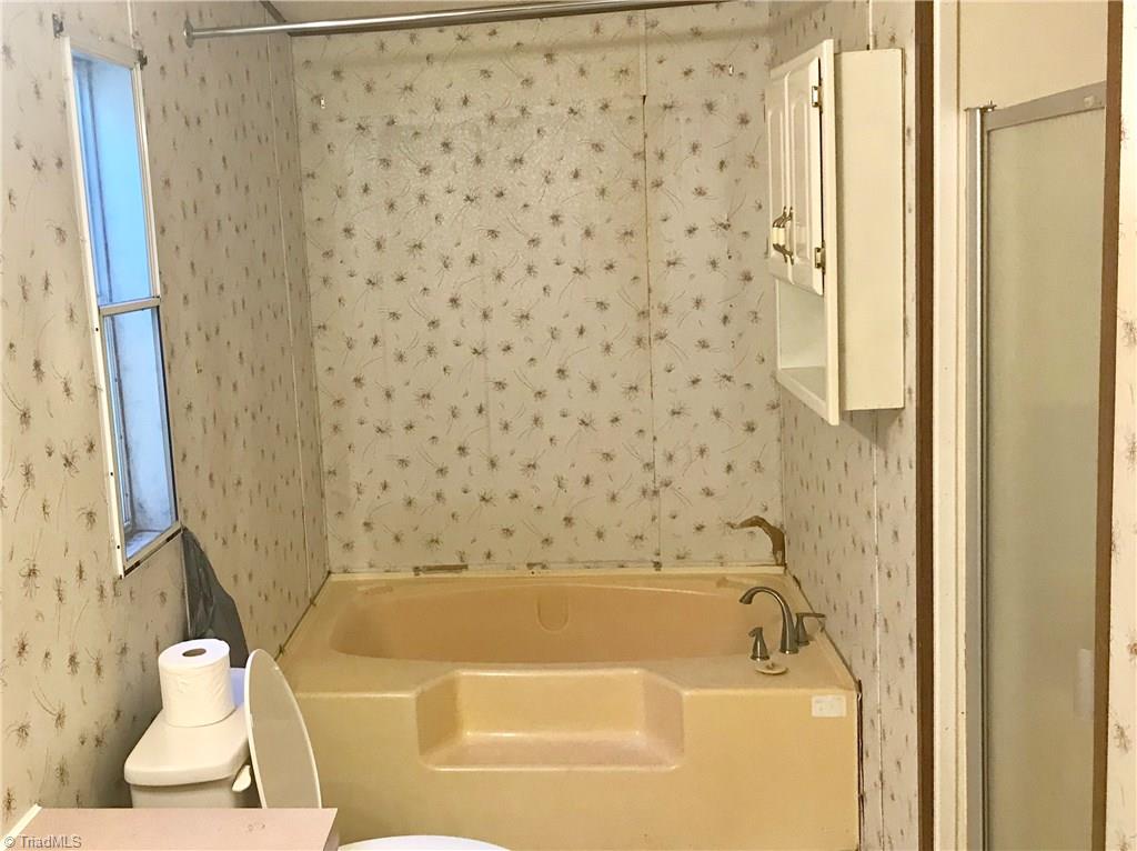 7797 Howard Mill Road Bennett, NC 27208 - Photo 9 of 16 Master bathroom with separate tub and shower