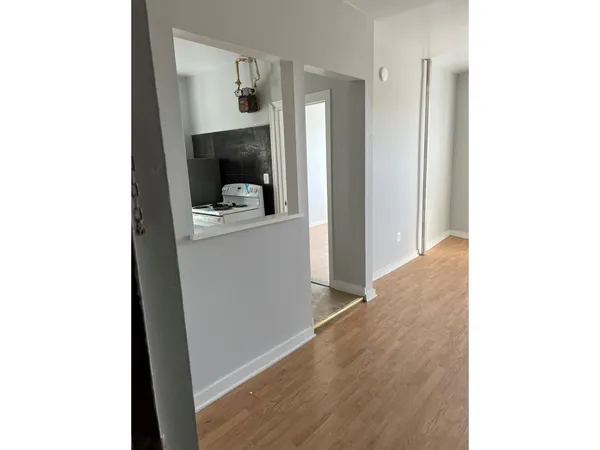 a view of a hallway with wooden floor