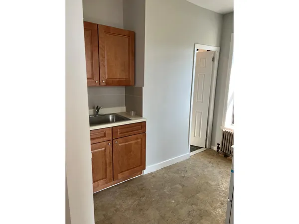 a room with a sink and cabinets