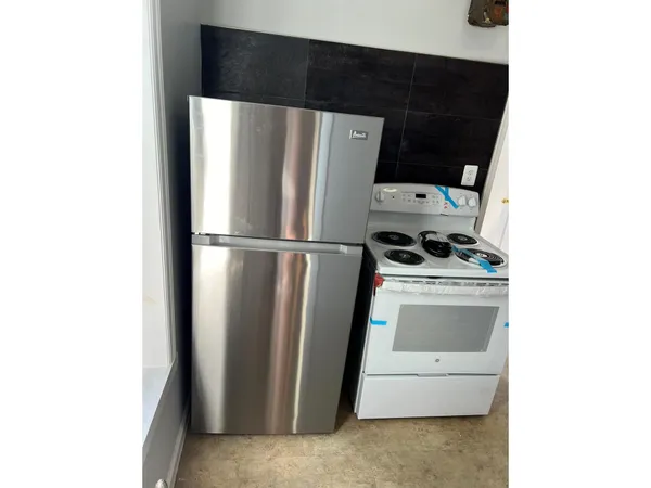 a view of a refrigerator in kitchen and wooden floor