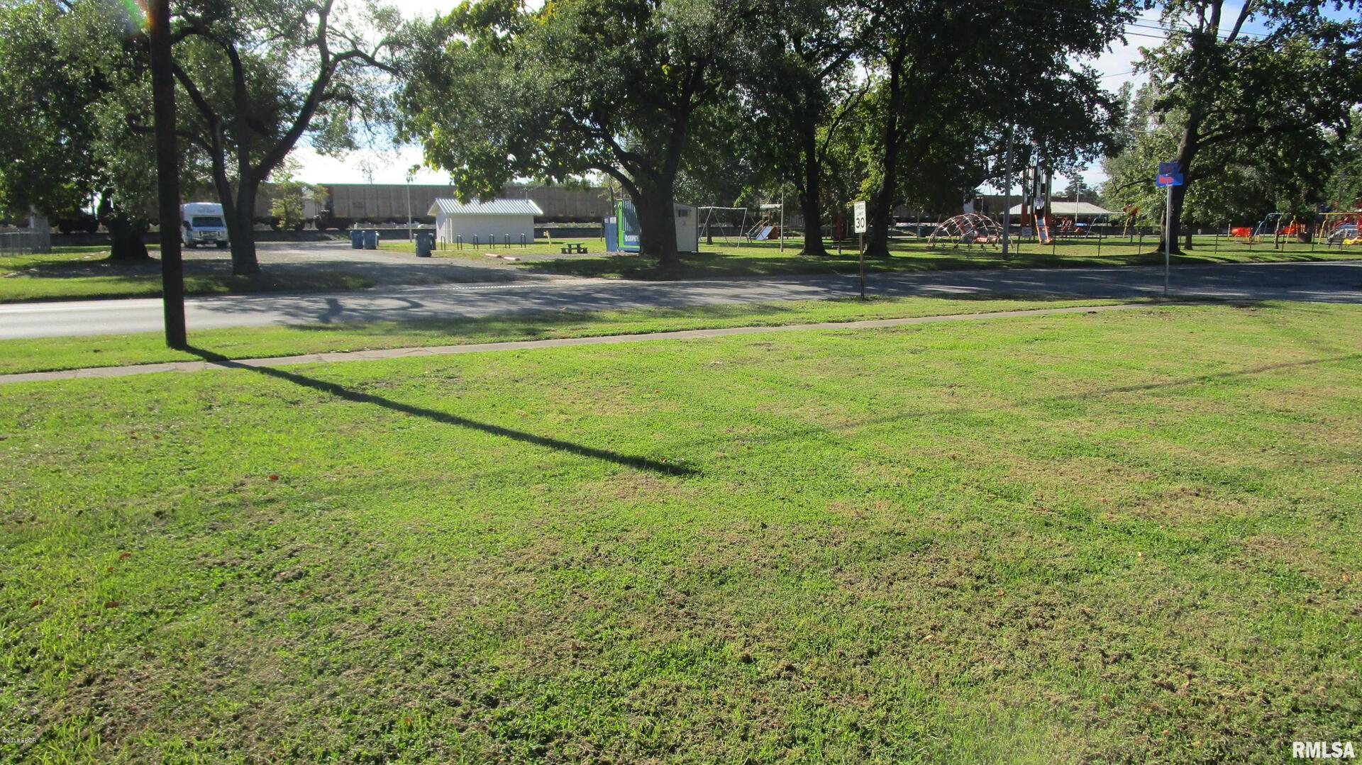 a view of yard with swimming pool and trees