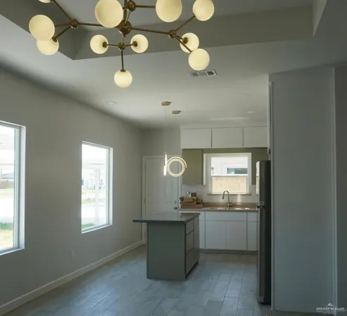 a kitchen with cabinets and window