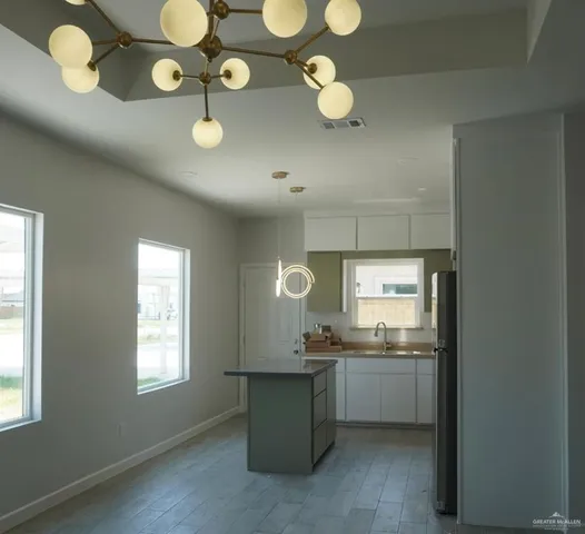 a kitchen with cabinets and window